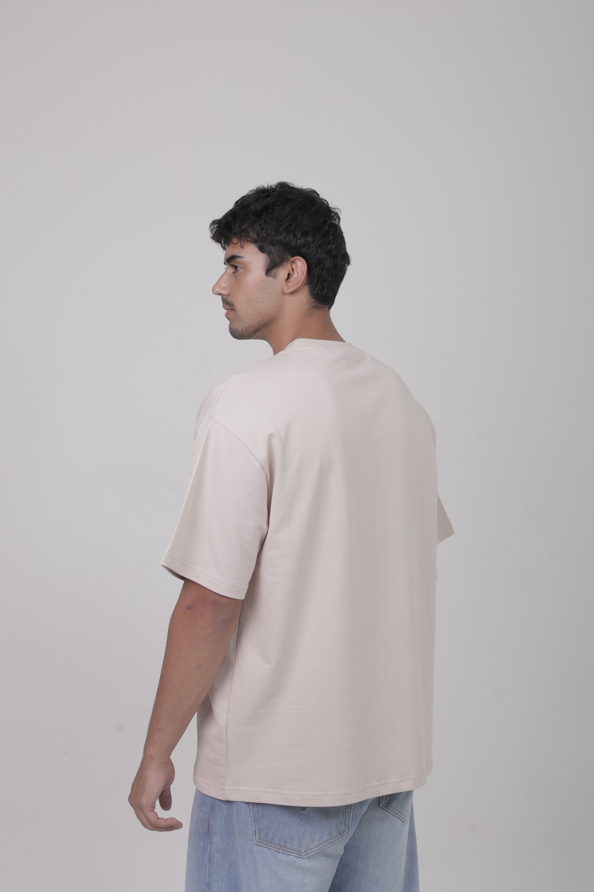 Back view of YuloLife solid beige oversized 240 GSM cotton terry tee showing drop-shoulder and premium structure.